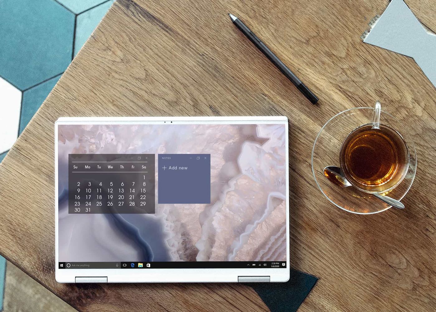 Laptop and cup of tea on a wooden table