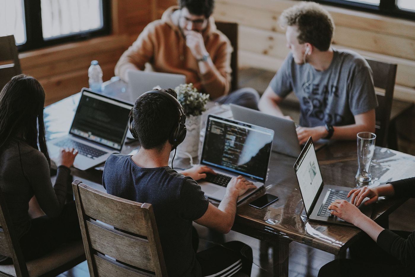 A team of marketers comparing affiliate programs on their laptops